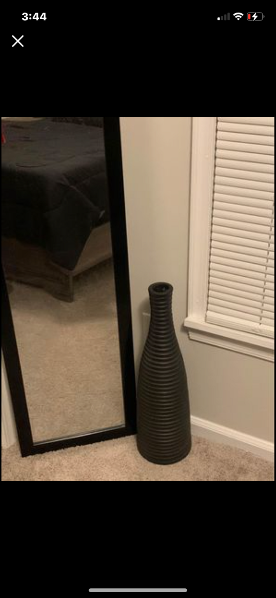 Black Floor Mirror and Decorative Vase