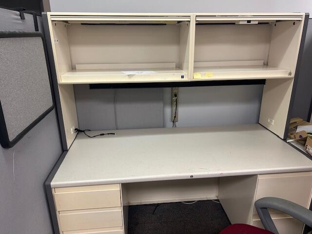 Cubicles, metal shelving, monitors