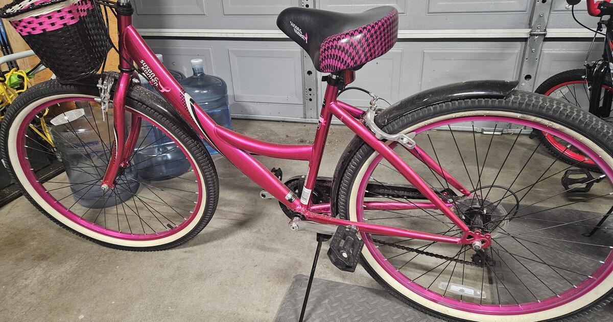 pink women's cruiser bike with basket