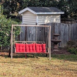 Outdoor Swing with Red Cushions
