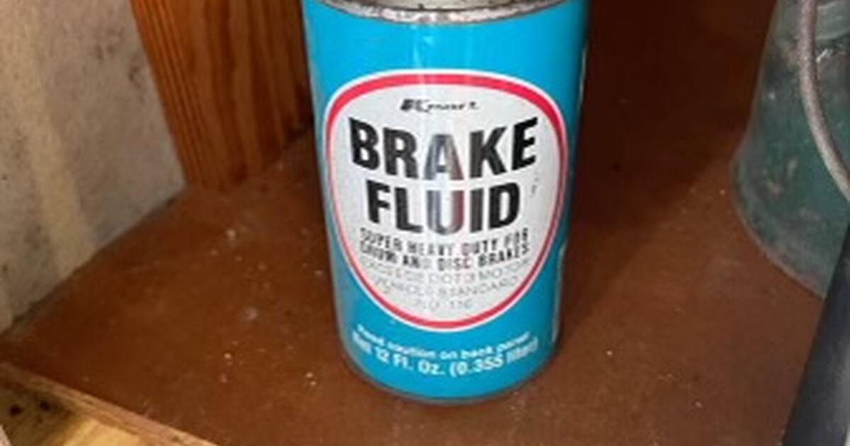 Vintage Kmart brake fluid metal can and 1974 small fire extinguisher