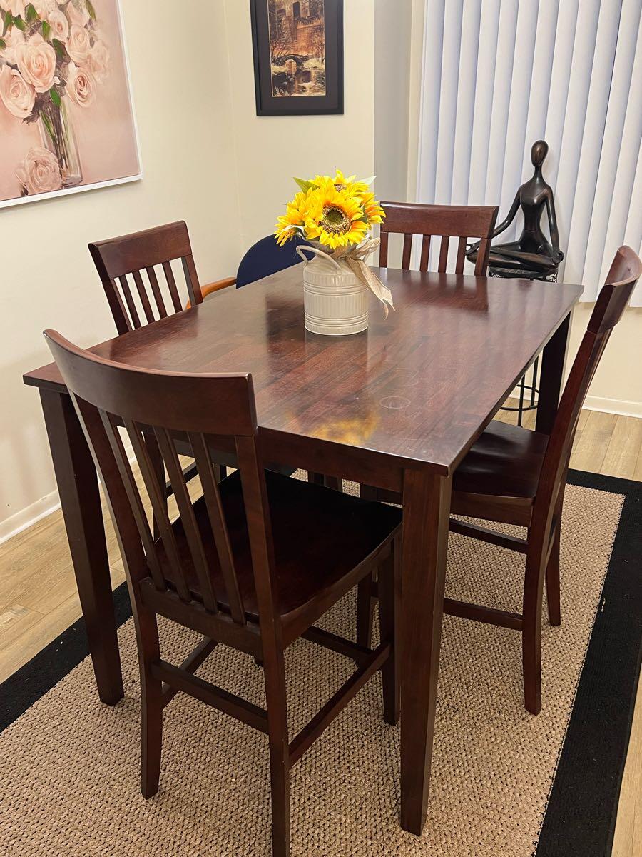 Wooden dining table with 4 chairs. Sectional sofa ideal for small space