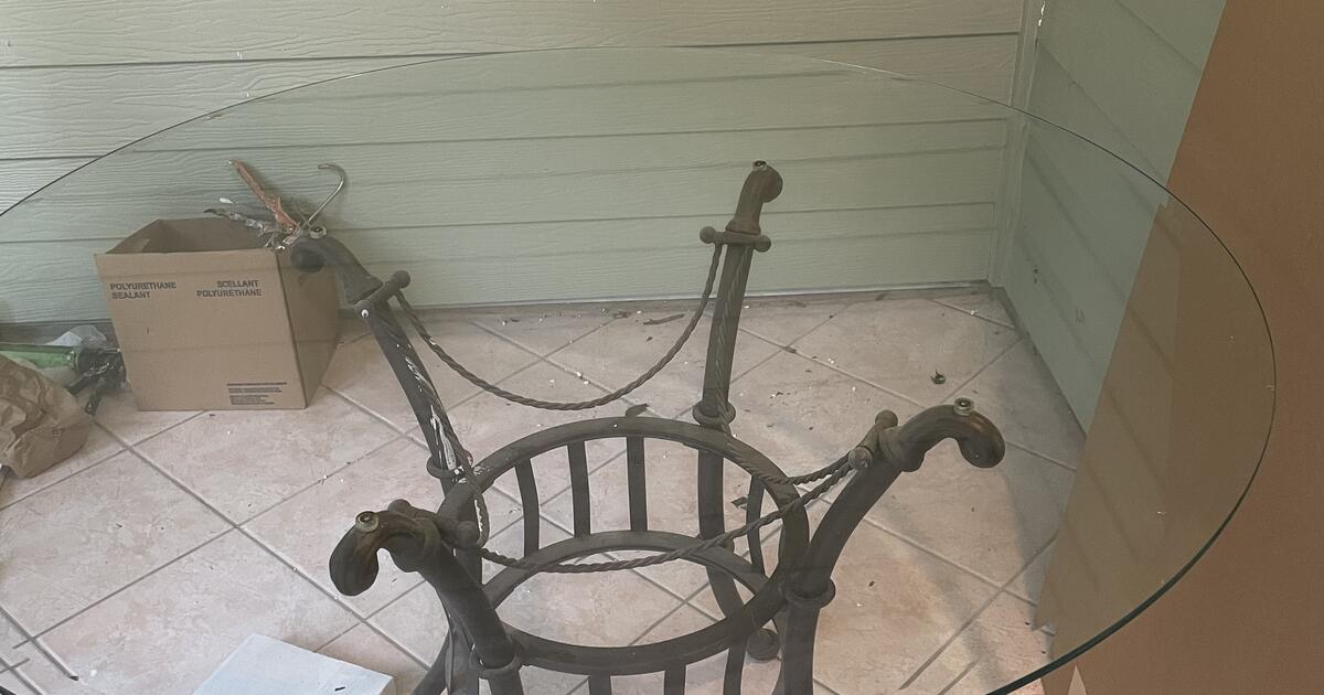 Glass and metal patio table with 4 chairs. for 45 in Jensen Beach, FL