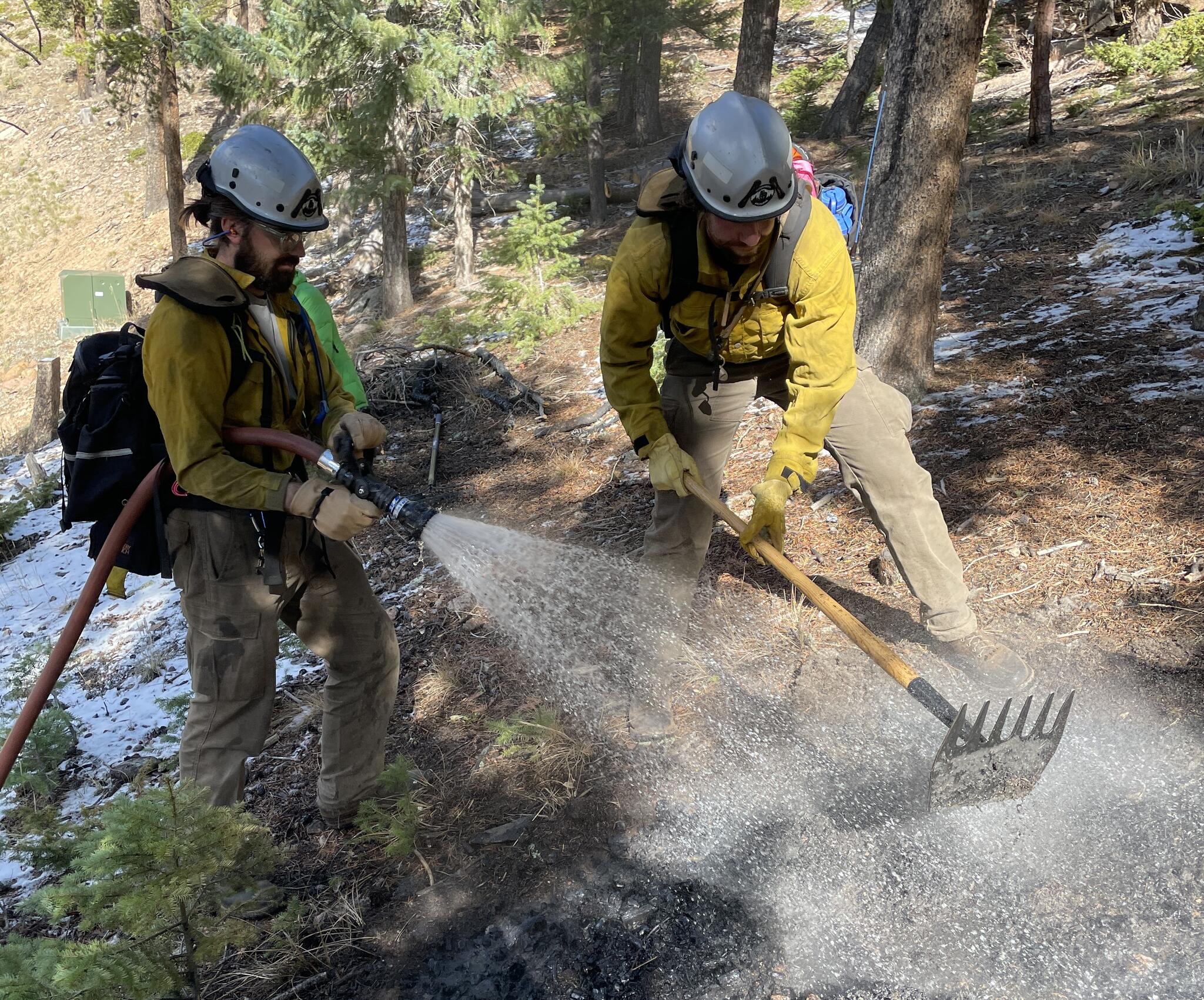 One of the firefighters in this photo is using a McLeod, a two-sided ...