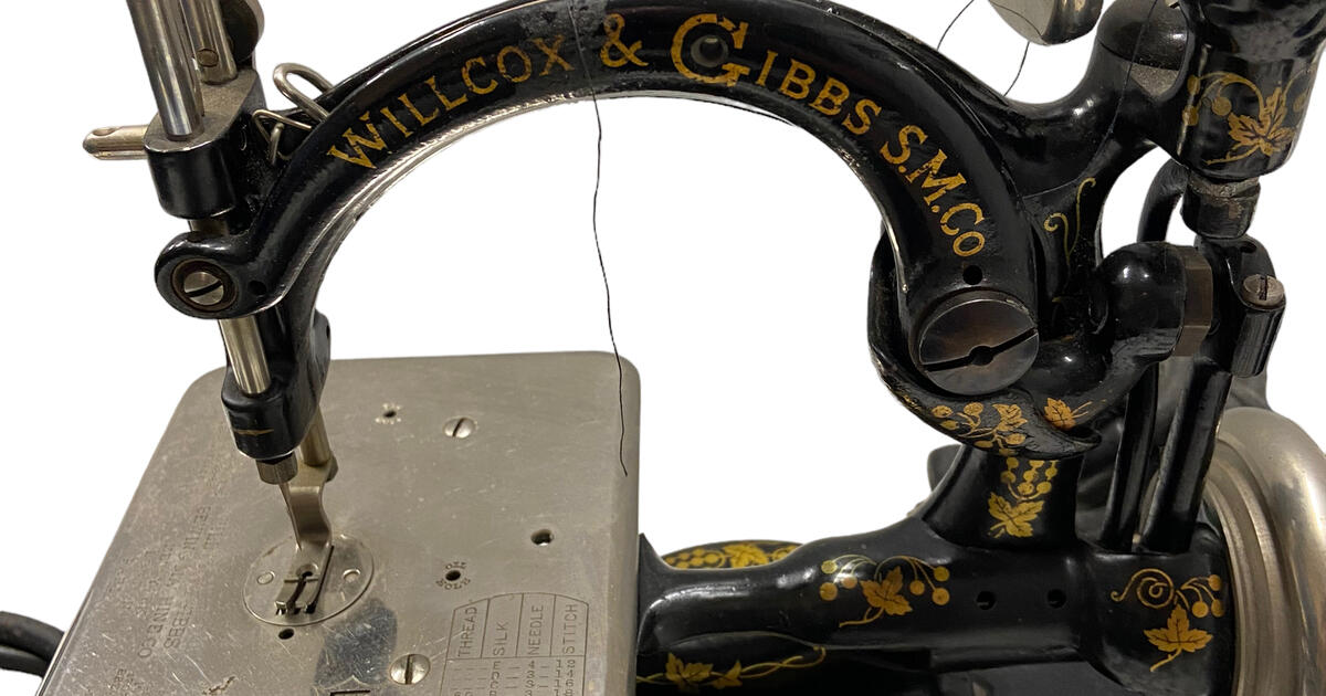 Antique Willcox and Gibbs Noiseless Sewing machine with accessories for