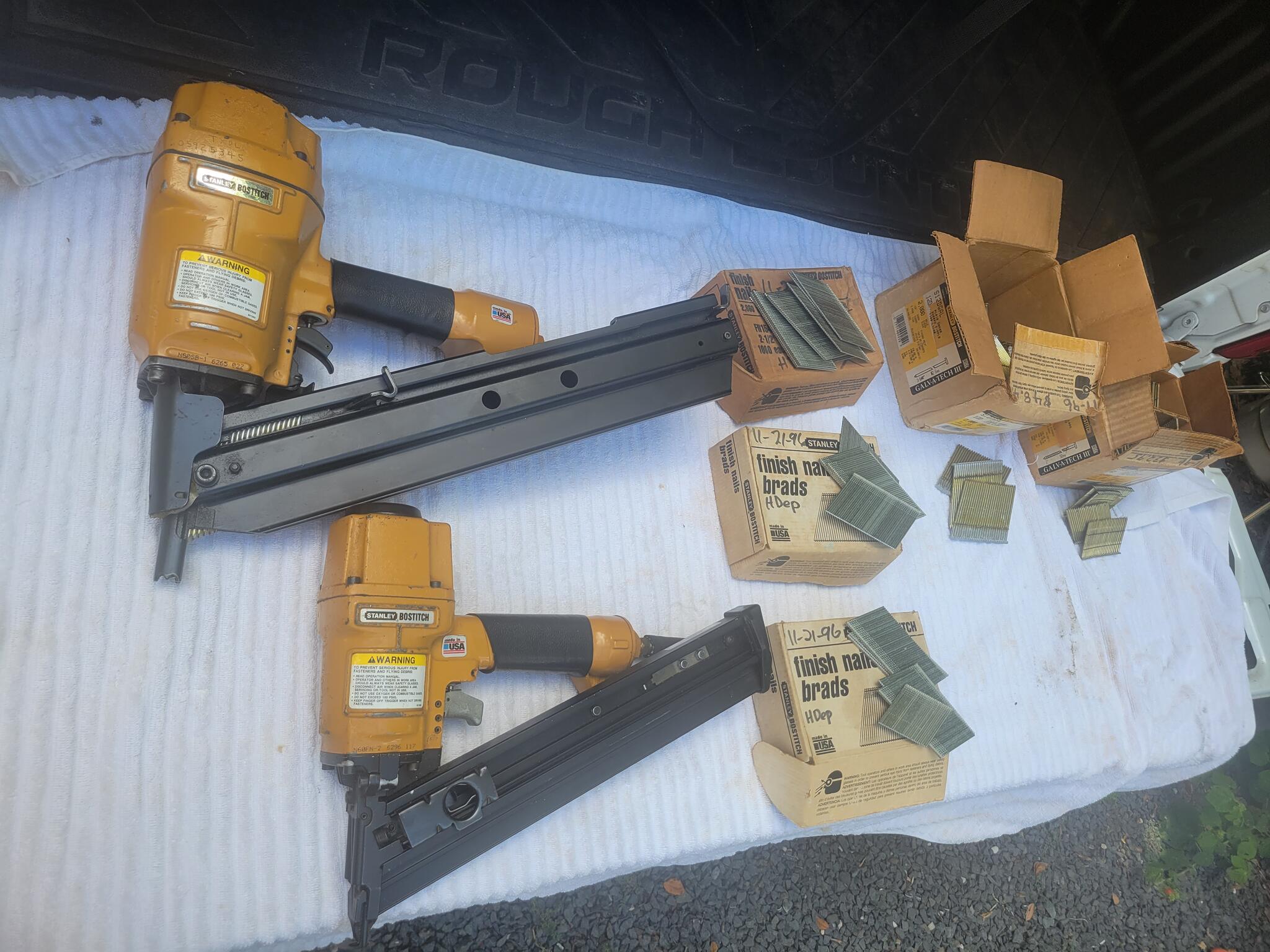 2 Bostitch nail guns 1 framing, 1 finishing with boxes of nails